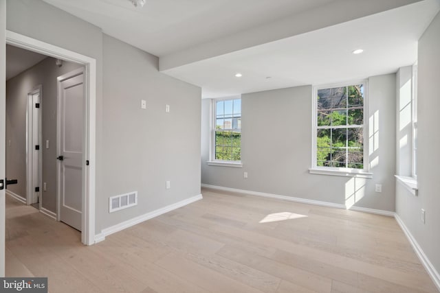 empty room with light wood-type flooring, baseboards, visible vents, and recessed lighting