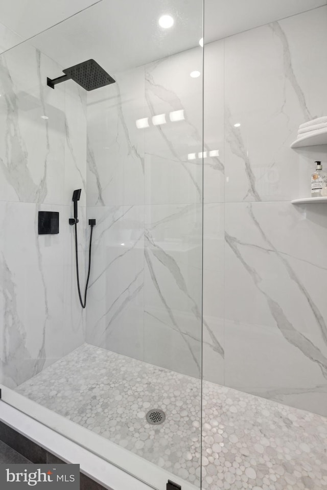 bathroom with a marble finish shower