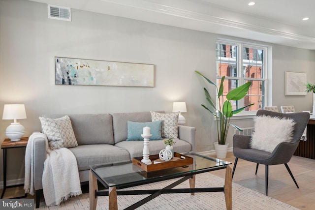 living area with recessed lighting, visible vents, and light wood finished floors