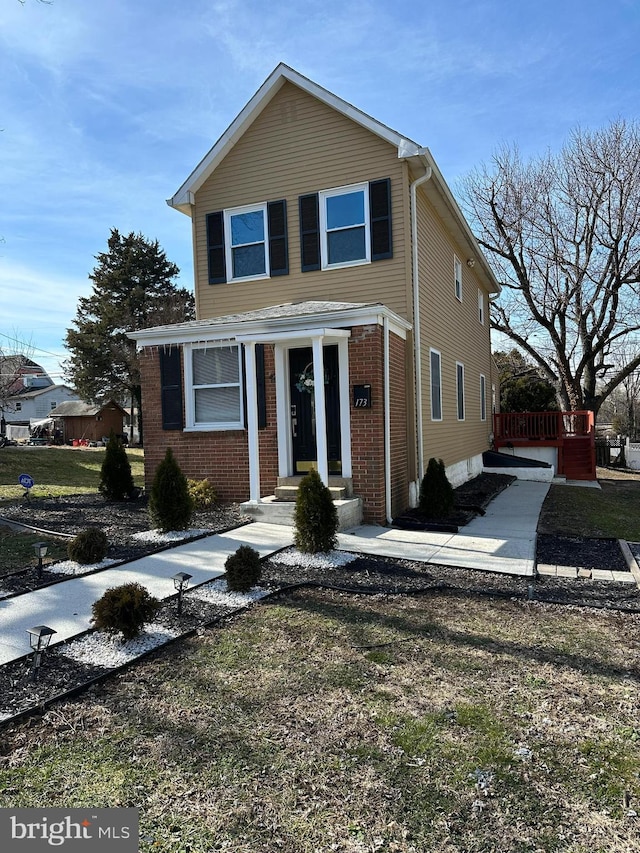 traditional-style home with brick siding