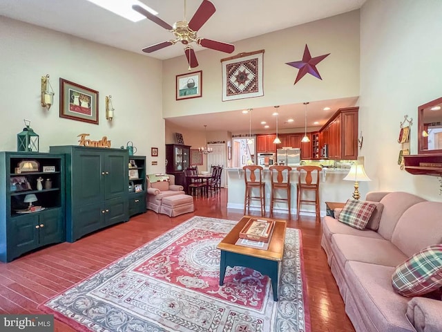 living room with ceiling fan, high vaulted ceiling, and dark wood-type flooring