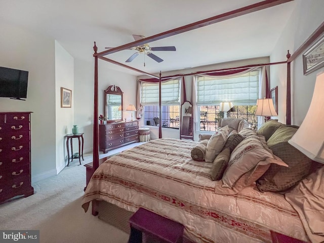 bedroom featuring a ceiling fan, light colored carpet, and baseboards