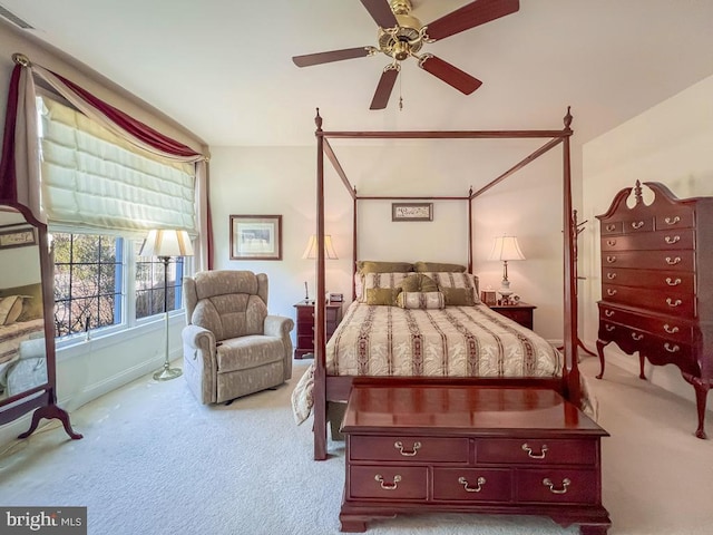 bedroom featuring light carpet, visible vents, and a ceiling fan