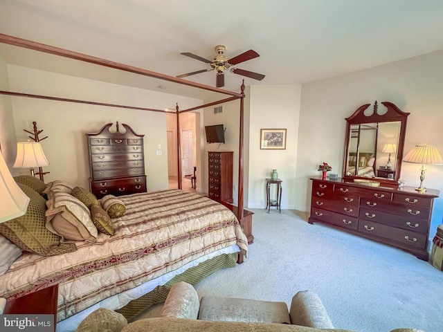 bedroom featuring a ceiling fan, light carpet, visible vents, and baseboards