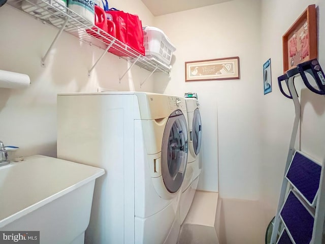 laundry room featuring laundry area, washer and clothes dryer, and a sink