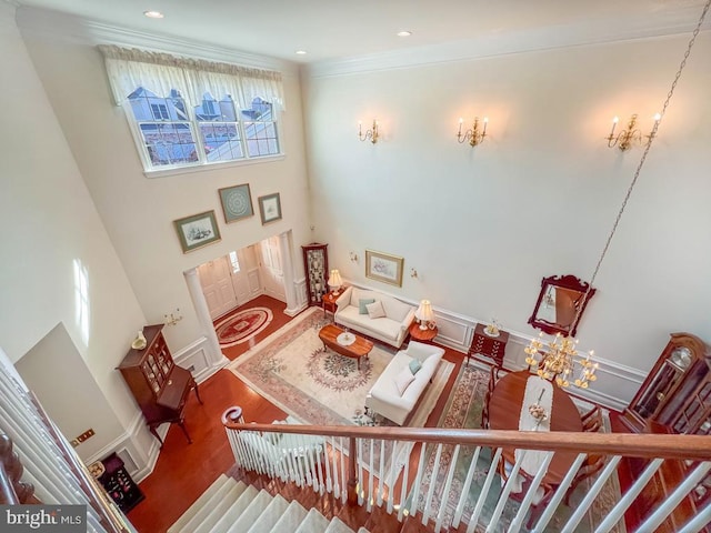 interior space with baseboards, ornamental molding, wood finished floors, and recessed lighting