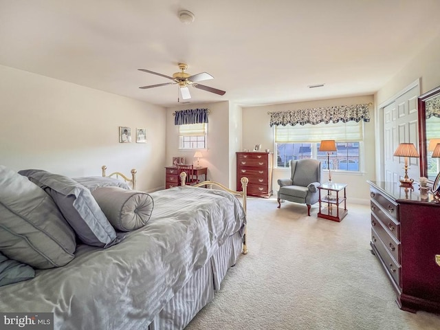 bedroom with light carpet and a ceiling fan