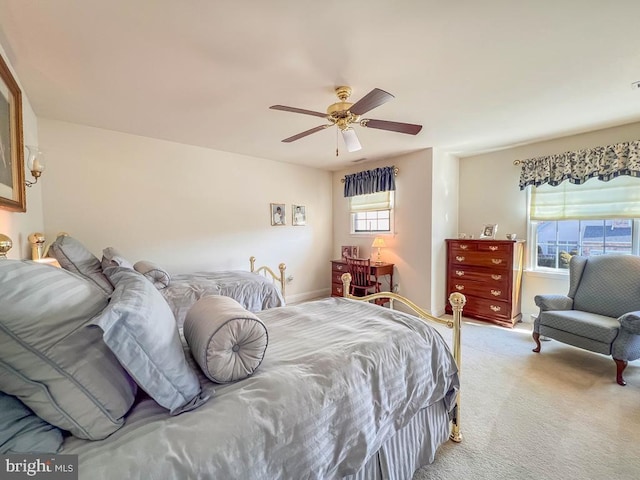 bedroom featuring a ceiling fan and light colored carpet