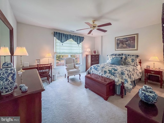 bedroom with visible vents, carpet flooring, and a ceiling fan