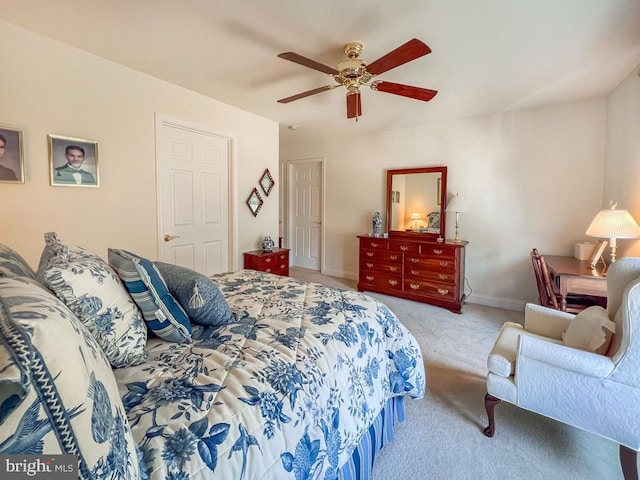 bedroom with ceiling fan, baseboards, and light colored carpet