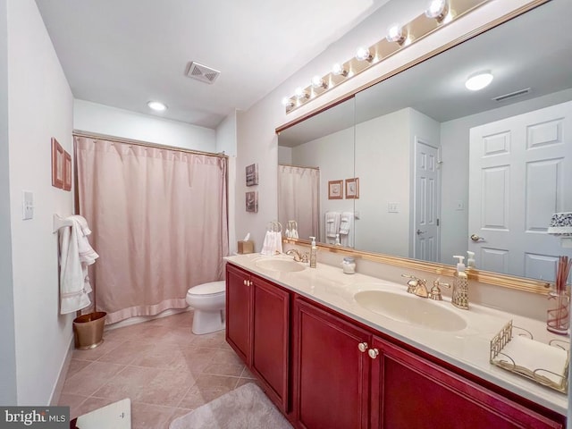 bathroom featuring visible vents, a sink, and double vanity