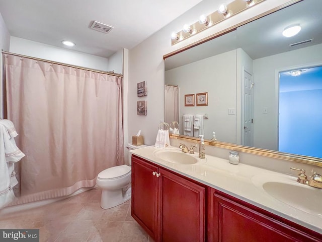 bathroom featuring double vanity, visible vents, and a sink