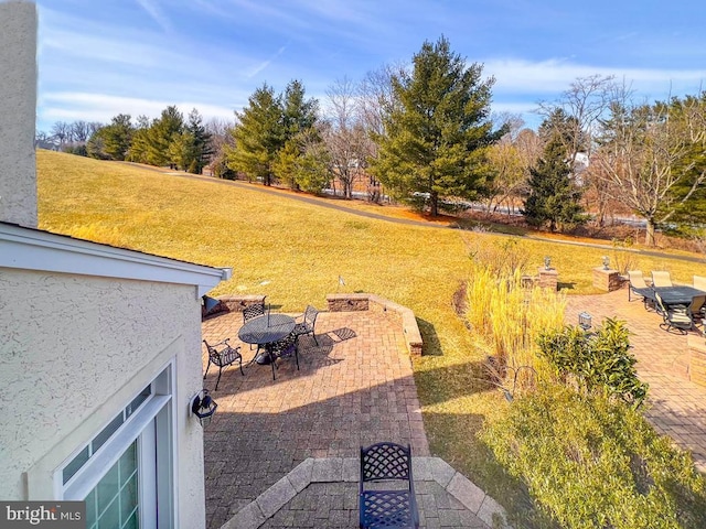 view of yard featuring a patio and outdoor dining space