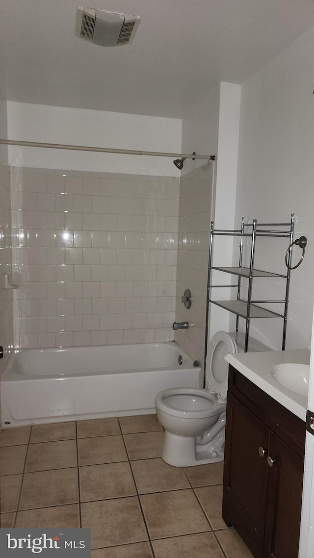 full bath featuring visible vents, toilet, tile patterned floors,  shower combination, and vanity