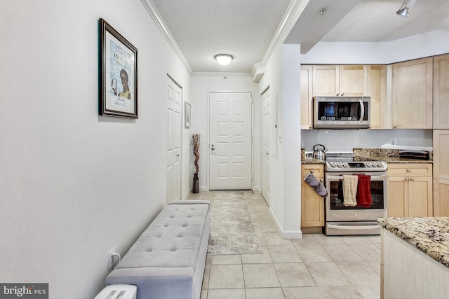 kitchen featuring light brown cabinets, ornamental molding, light stone counters, appliances with stainless steel finishes, and light tile patterned flooring