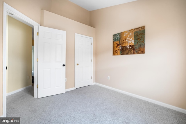 unfurnished bedroom with carpet and baseboards