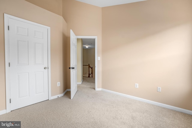 unfurnished bedroom featuring carpet flooring and baseboards