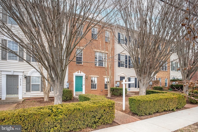 townhome / multi-family property featuring brick siding