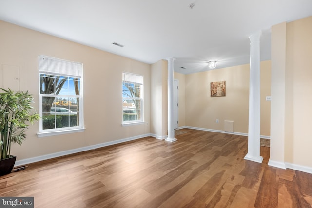 interior space featuring plenty of natural light and ornate columns