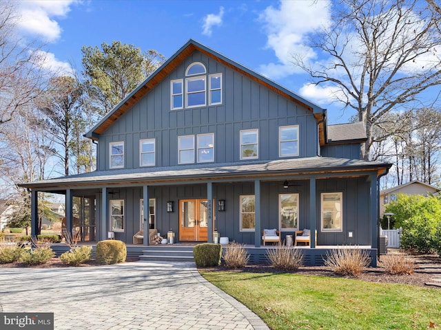 view of front facade featuring a porch, board and batten siding, and french doors