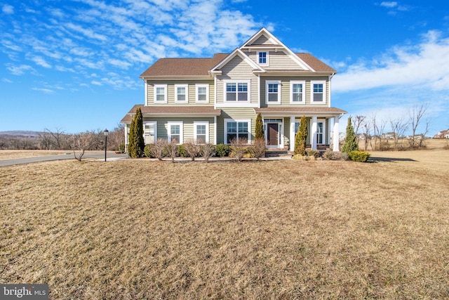 view of front of house featuring a front yard and covered porch