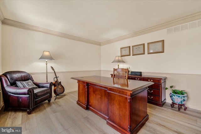 office area with baseboards, visible vents, crown molding, and light wood finished floors