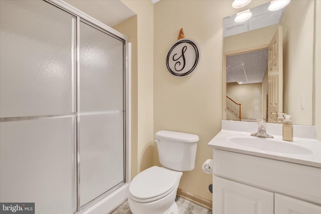 bathroom with visible vents, toilet, a shower stall, vanity, and baseboards