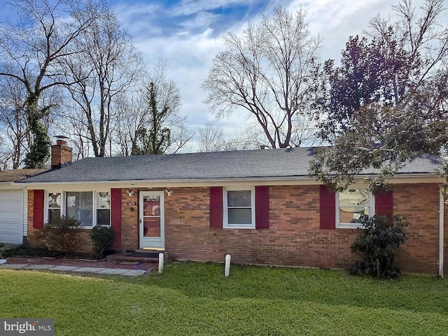 single story home featuring a shingled roof, a chimney, an attached garage, a front lawn, and brick siding