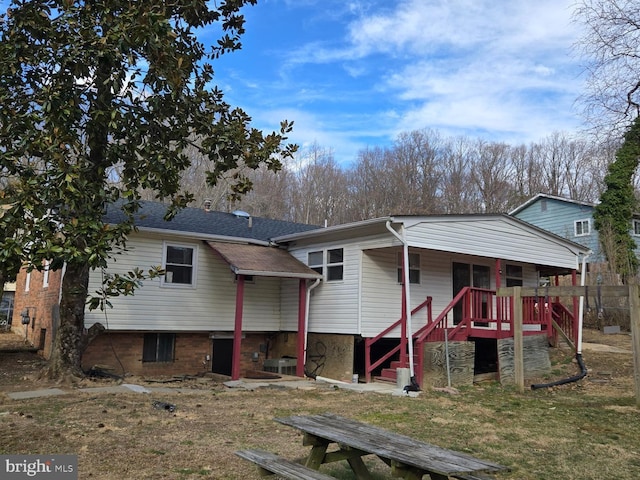 view of front of home with stairway and roof with shingles