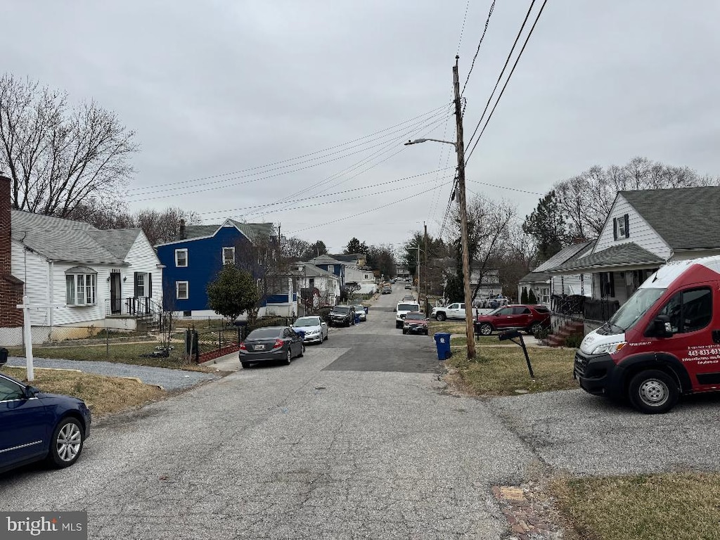 view of road with a residential view and street lights