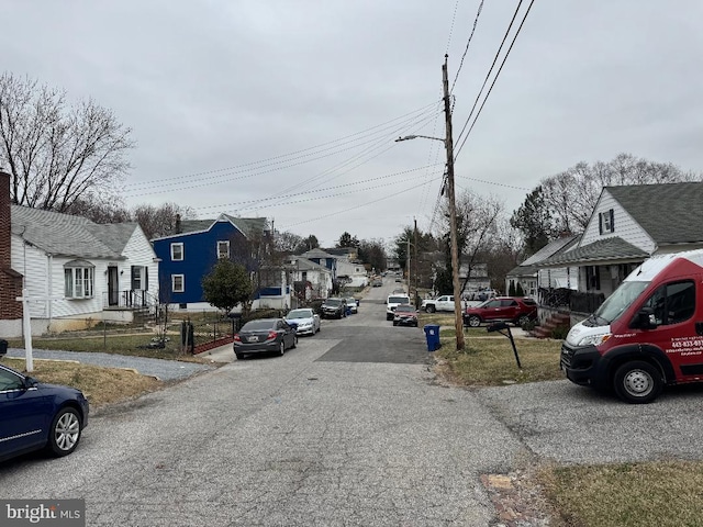 view of road with a residential view and street lights