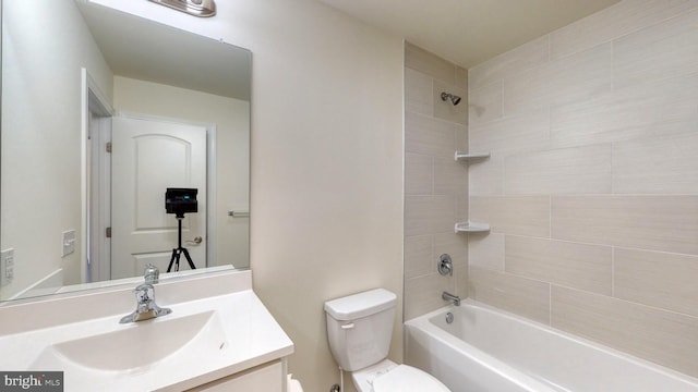 full bath featuring toilet, vanity, and bathing tub / shower combination