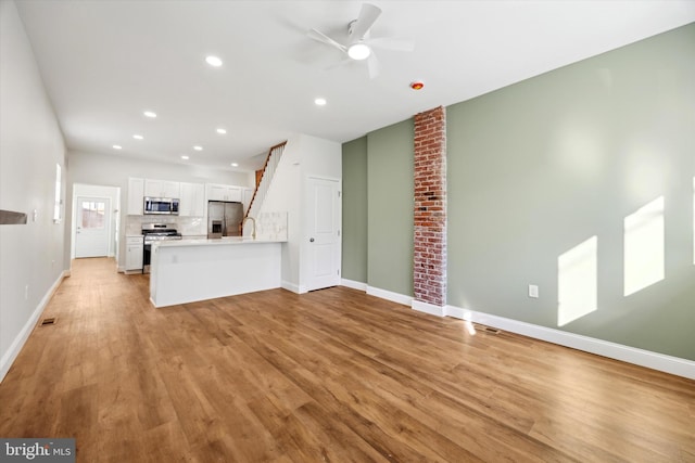 unfurnished living room featuring ceiling fan, light wood-style flooring, recessed lighting, visible vents, and baseboards