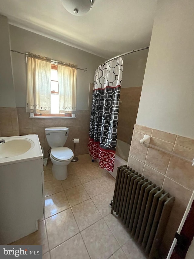 bathroom with tile walls, shower / bath combination with curtain, radiator, toilet, and tile patterned floors