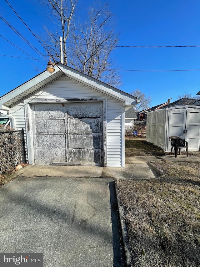 detached garage featuring fence