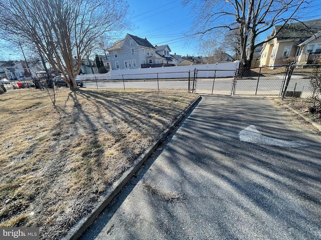 view of yard with a residential view, a gate, and fence