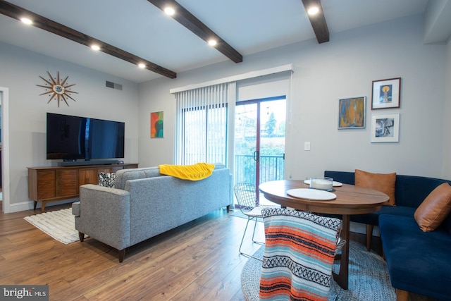 living area with recessed lighting, visible vents, wood finished floors, beamed ceiling, and baseboards