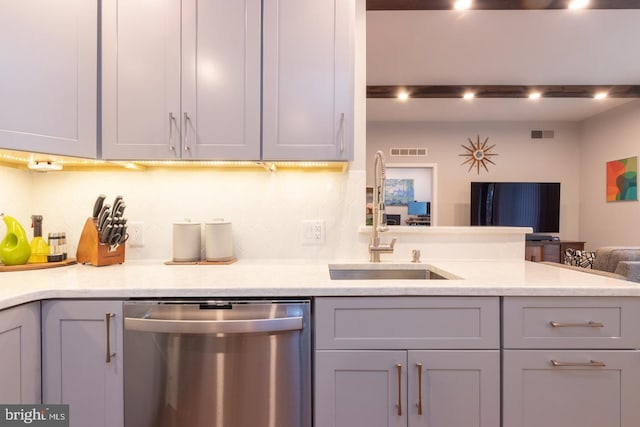 kitchen with gray cabinetry, visible vents, a sink, and stainless steel dishwasher