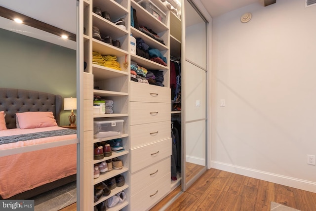 bedroom with light wood-type flooring and baseboards