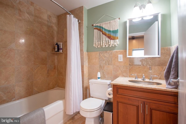 full bathroom featuring toilet, tile patterned floors, shower / bath combination with curtain, vanity, and tile walls