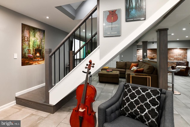 stairway with recessed lighting, baseboards, a high ceiling, and tile patterned floors