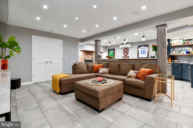 living room with bar area, recessed lighting, and ornate columns