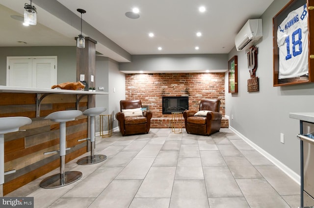 sitting room featuring baseboards, an AC wall unit, recessed lighting, a fireplace, and light tile patterned flooring