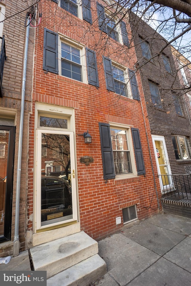 property entrance with brick siding