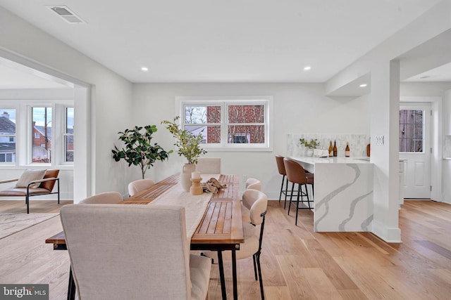 dining space featuring a healthy amount of sunlight, recessed lighting, visible vents, and light wood-style floors