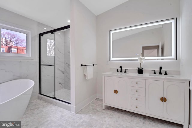 full bathroom with a sink, a marble finish shower, and double vanity