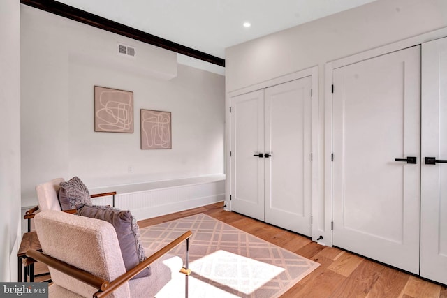 living area featuring light wood-type flooring, visible vents, and recessed lighting