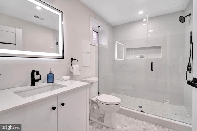 bathroom featuring a stall shower, visible vents, vanity, and toilet