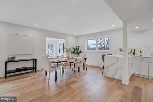 dining area with light wood-style floors, baseboards, and recessed lighting