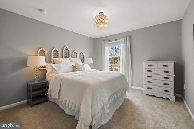 bedroom featuring carpet and baseboards